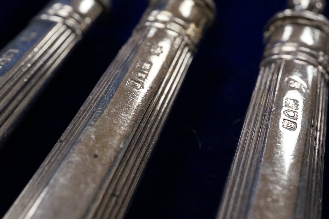 A set of twelve pairs of silver dessert eaters, by Thomas Bradbury & Sons, London, 1913, knife 19.8cm, handles loaded, housed in a fitted oak canteen.
